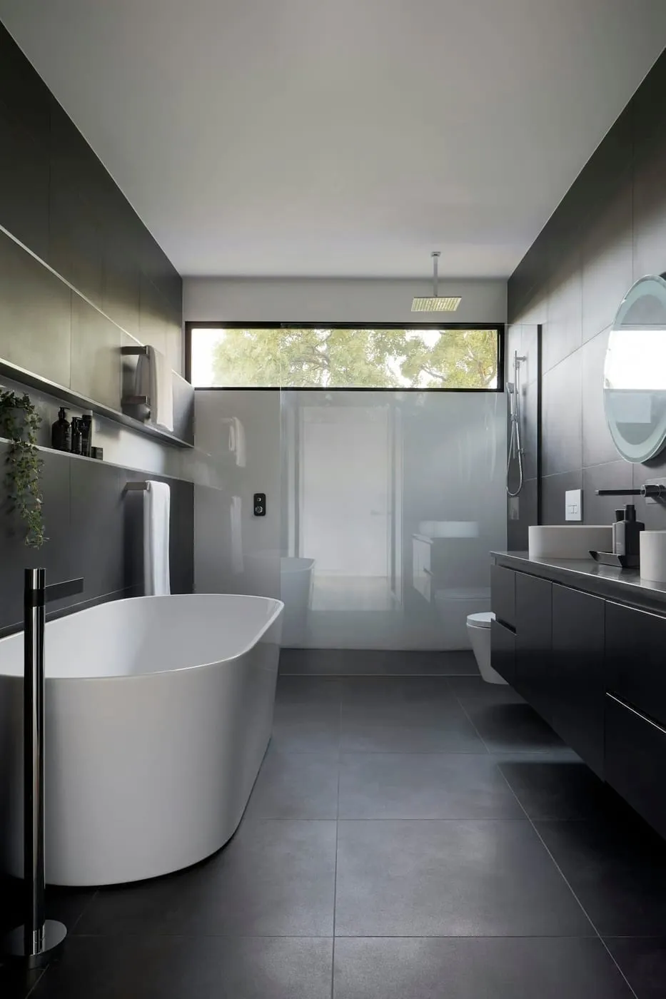 Bathroom vanity with mirrored storage and a recessed wall niche shelf keeping toiletries organized and off the counter