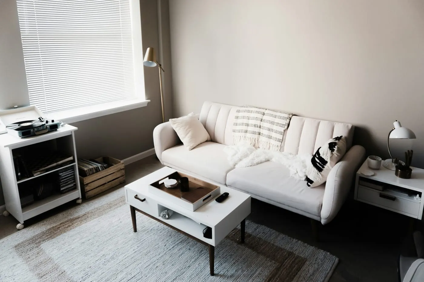 A well-organized small apartment living room with KALLAX storage and clear surfaces