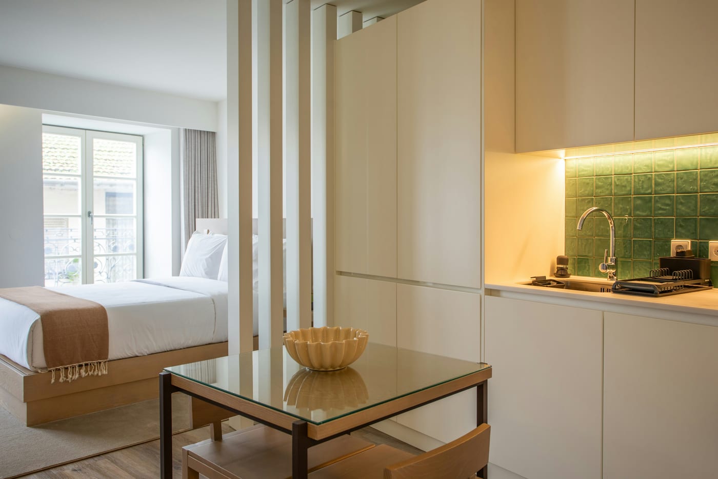 Two rugs define separate living and sleeping zones in a studio apartment