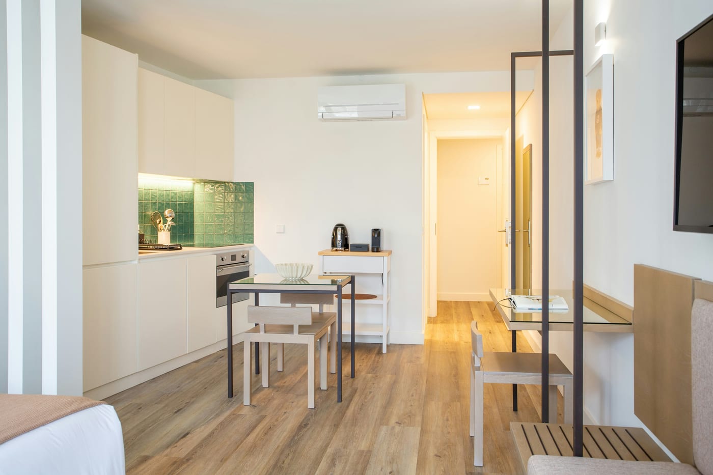 A dedicated compact workspace in a studio apartment keeps work and rest mentally separate
