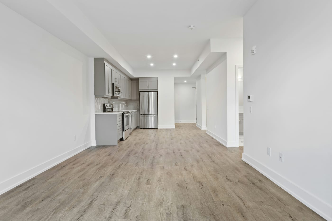 Ceiling curtains create a private sleeping area inside a studio apartment