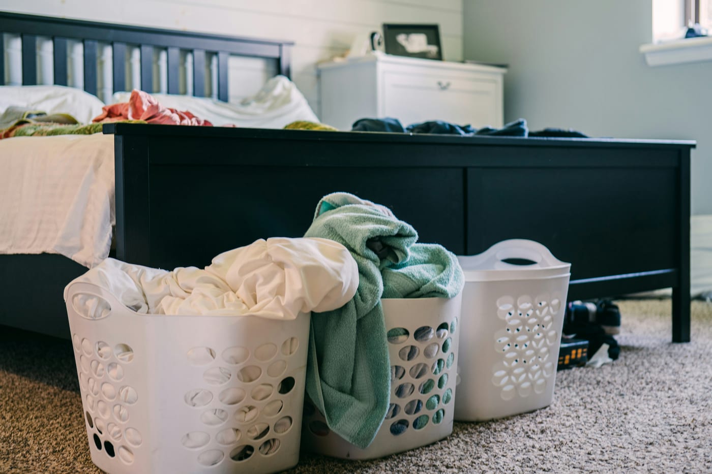 Command hooks at a small apartment entryway keep coats, bags, and keys off the floor