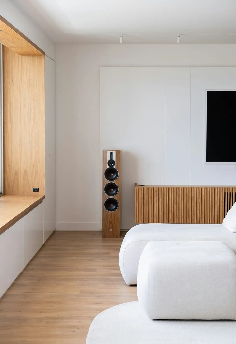 Multi-functional furniture in a small apartment — storage ottoman and KALLAX doing double duty