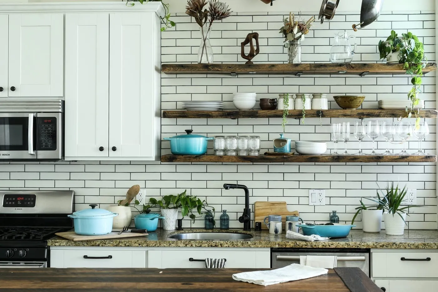 Clear stackable pantry bins labeled by category — everything visible at a glance in a small apartment kitchen