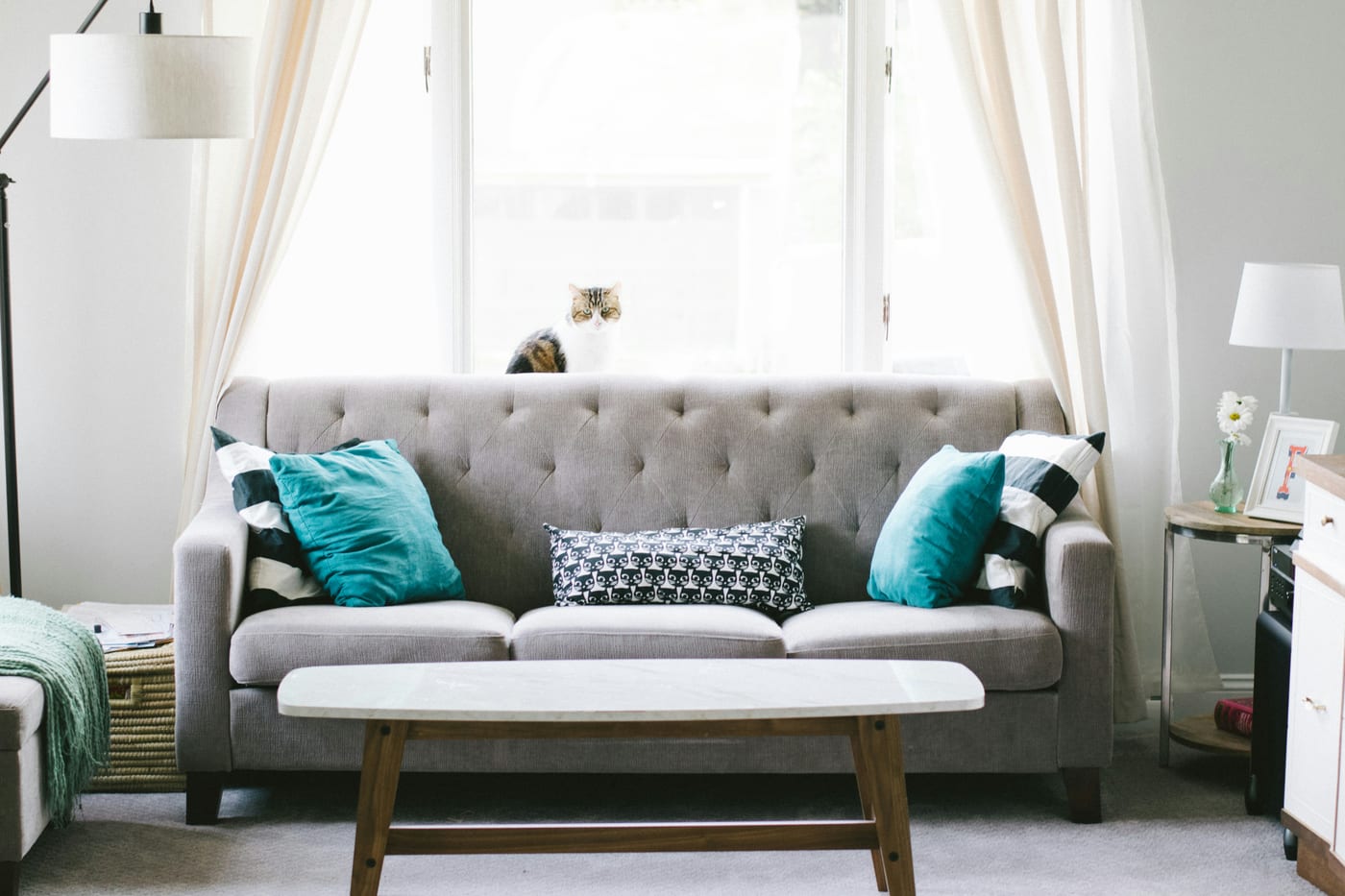 A cozy Canadian apartment living room lit with warm lamps and candles — the foundation of winter comfort