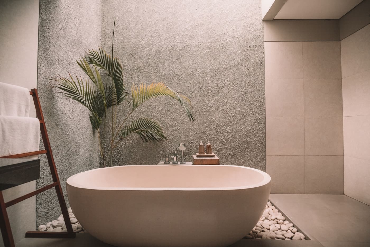 Wooden tray corralling only daily-use toiletries in one spot, leaving the rest of the bathroom surfaces clear